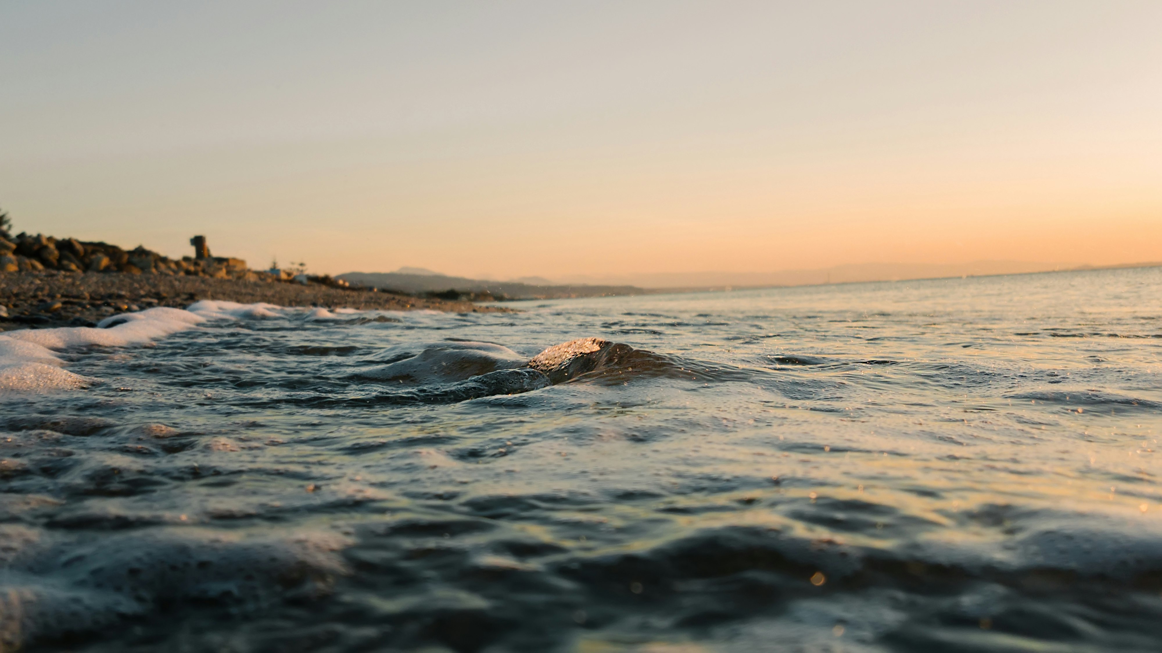 low angle photography of ocean wave at beach